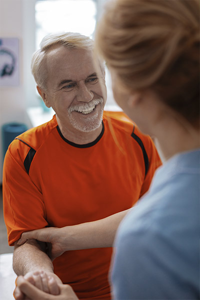 Female Doctor In White Coat Having Meeting With Woman Patient In Office
