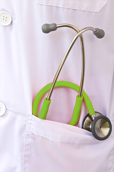 Female Doctor In White Coat Having Meeting With Woman Patient In Office